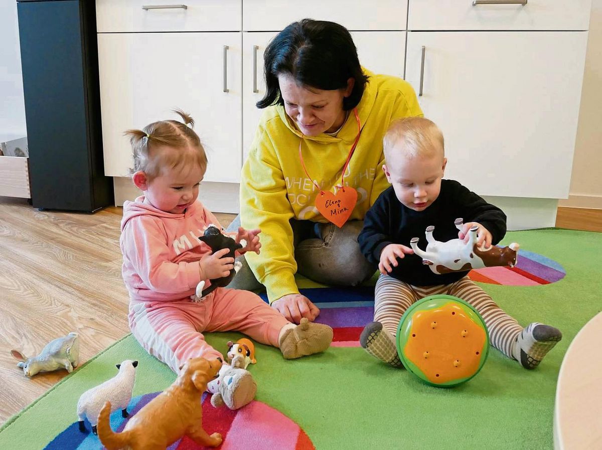 Mit großem Interesse erkunden Mina und Karlo verschiedene Tierfiguren wie etwa eine Katze und eine Kuh.