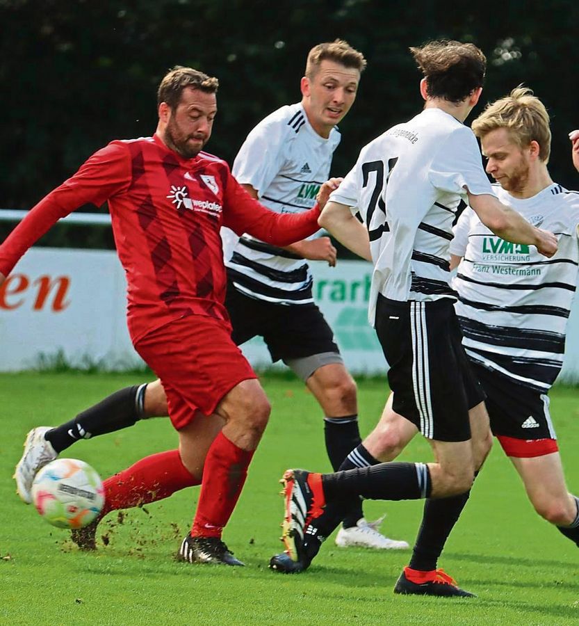 45 Minuten agierten die Langeneicker (in Weiß-Schwarz) im Heimspiel gegen Erwitte (Rot) in Unterzahl. Löer sah kurz vor dem Pausentee nämlich glatt Rot. Tim Essers rettete seiner Mannschaft per Elfmeter in der Nachspielzeit dann aber noch das Remis. Foto: Feichtinger