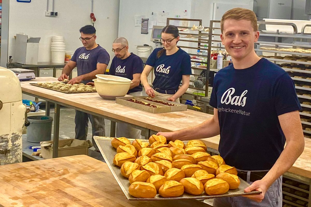 Wenn wir schlafen, kneten und backen sie: Junior-Chef Michael Bals (r.) und drei Mitarbeiter in der neuen Backstube in Lipperbruch. Foto: Vielberg