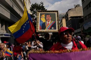 Ein Anhänger der Regierung hält ein Bild von Präsident Nicolas Maduro. - Foto: Matias Delacroix/AP/dpa