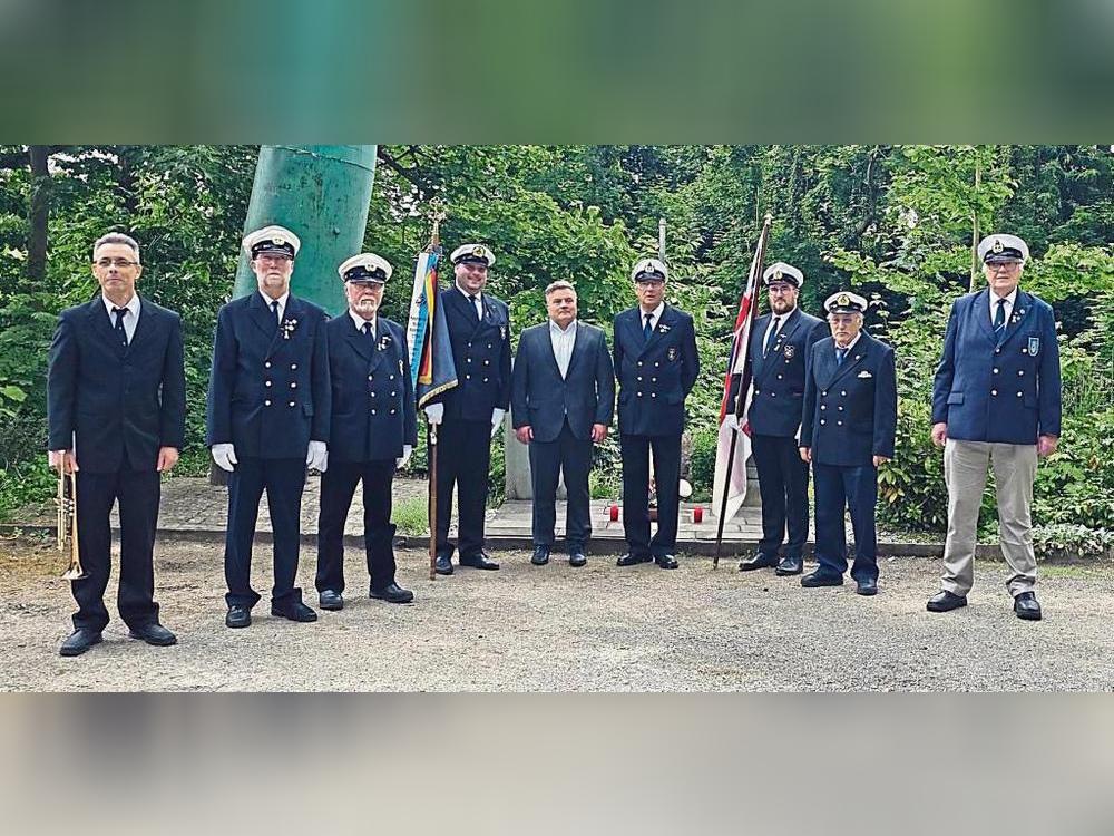 Gedachten den Opfern der Kriege (v.l.): Trompeter Russell Hibbs, Reinhard Linhoff, Ulrich Köster, Schatzmeister Dennis Bömelburg, Bürgermeister Arne Moritz, Vorsitzender Heinz-Werner Strube, stellv. Vorsitzender Bastian Dörries, Franz-Josef Plotzki und Herbert Lutterbüse. Foto: H. Wissing