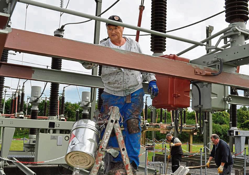 Handwerker einer Spezialfirma aus Witten bearbeiten in der Umspannanlage am Roßfeld Metallportale eines Sammelschienenabschnitts.