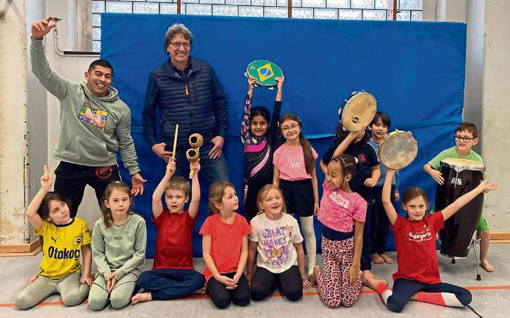 Capoeira-Profi William Gomes Soares (l.) und Schulleiter Andreas Brauckmann (hinten, 2.v.l.) mit den Friedrichschülern.