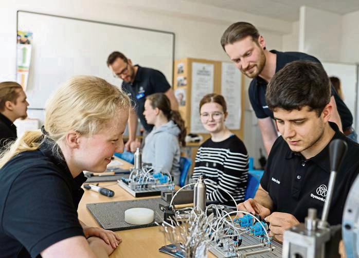 Milena Ebers, links (selbst Azubi) von ThyssenKrupp erklärt die Funktionsweise einer Pneumatikanlage