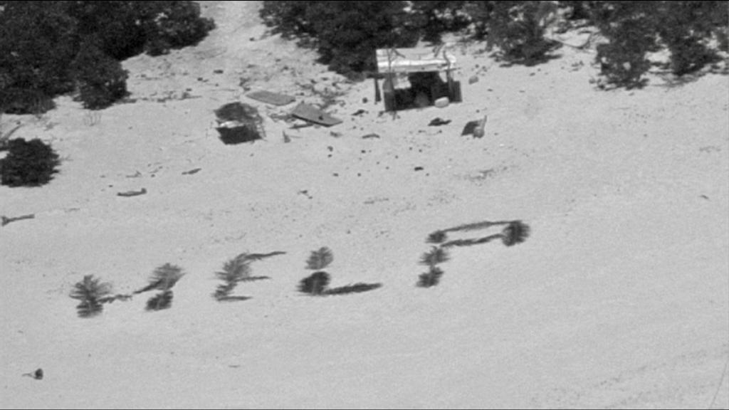 «Bemerkenswertes Zeugnis ihres Willens, gefunden zu werden»: «Help» mit Palmwedeln auf Sand geschrieben. - Foto: U.S. Coast Guard/dpa