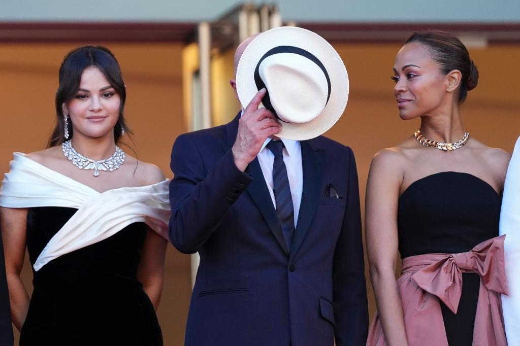 Jacques Audiard spielt Verstecken: Der französische Regisseur stellt beim Filmfestival in Cannes zusammen mit Selena Gomez (l) und Zoe Saldana seine Musical-Komödie «Emilia Perez» vor. - Foto: Scott A Garfitt/Invision/AP/dpa