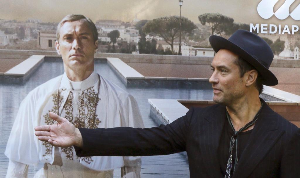 Jude Law vor einem Plakat mit sich als Papst Pius XIII. in der Serie «The Young Pope». (Archivbild) - Foto: picture alliance / dpa
