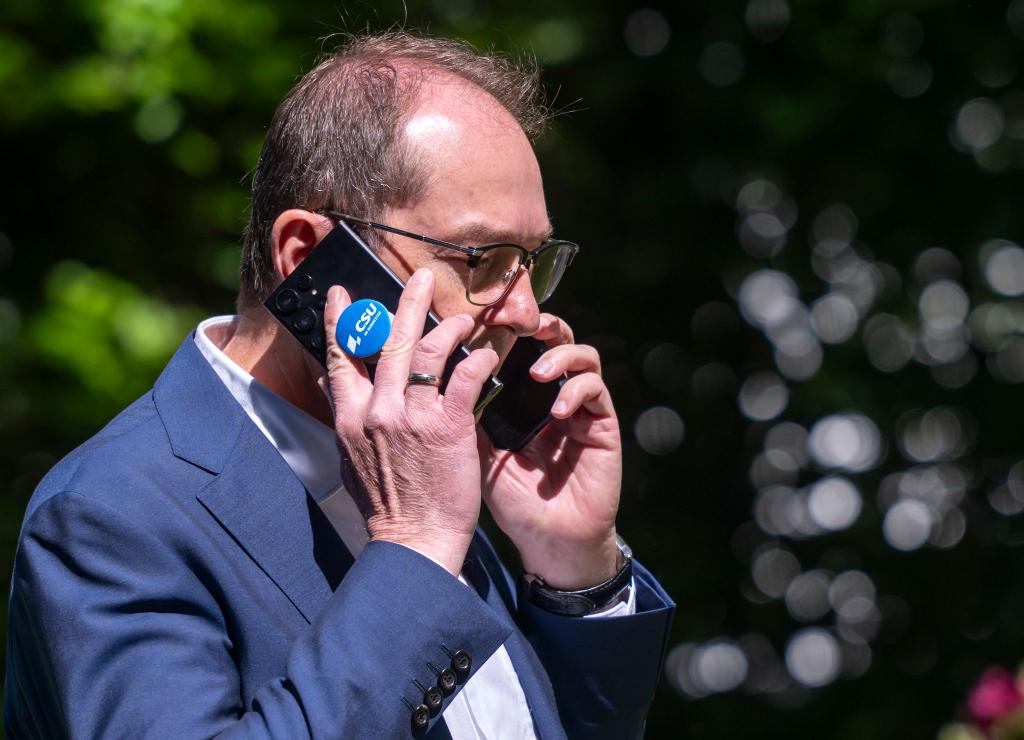 Mr. Multitasking: Alexander Dobrindt mit zwei Telefonen - Foto: Peter Kneffel/dpa