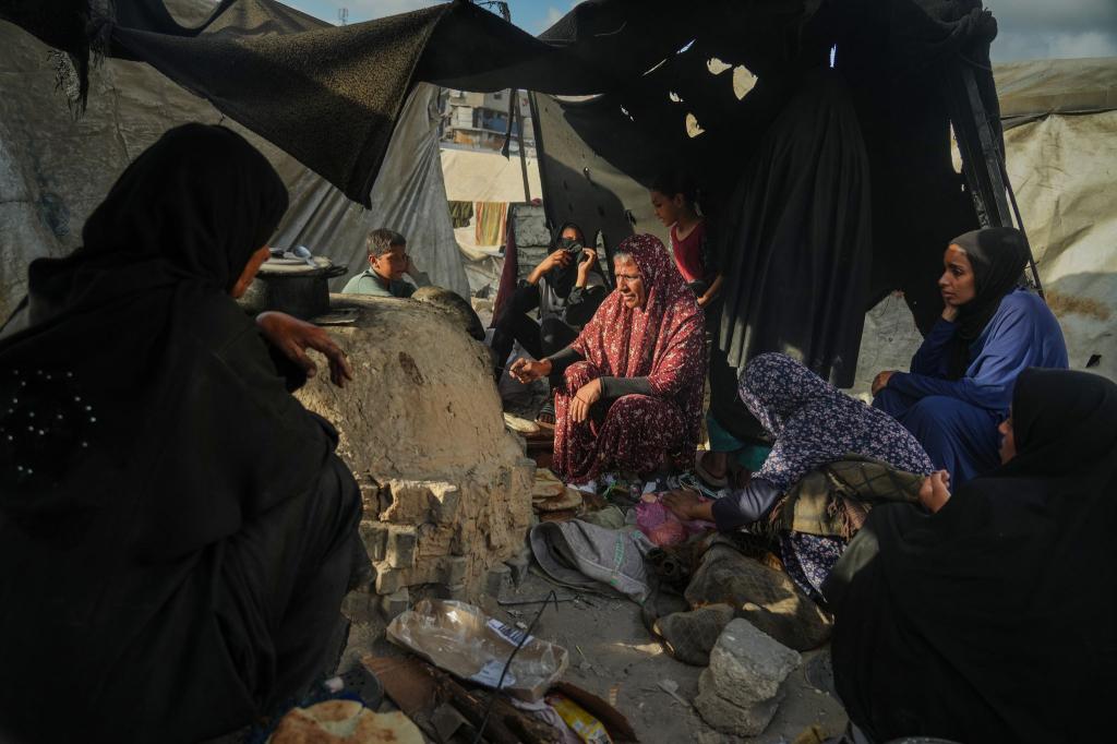 Palästinensische Frauen backen Brot in Notunterkunft. - Foto: Jehad Alshrafi/AP/dpa