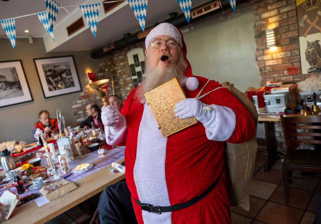 Bastian Kluth, einer der Teilnehmer der Weihnachtsmann-Schulung, zeigt sein Kostüm. - Foto: Thomas Banneyer/dpa