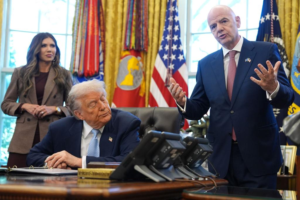 US-Präsident Donald Trump (M) droht mit Spielverlegungen, FIFA-Präsident Gianni Infantino gibt sich zurückhaltend. - Foto: Evan Vucci/AP/dpa